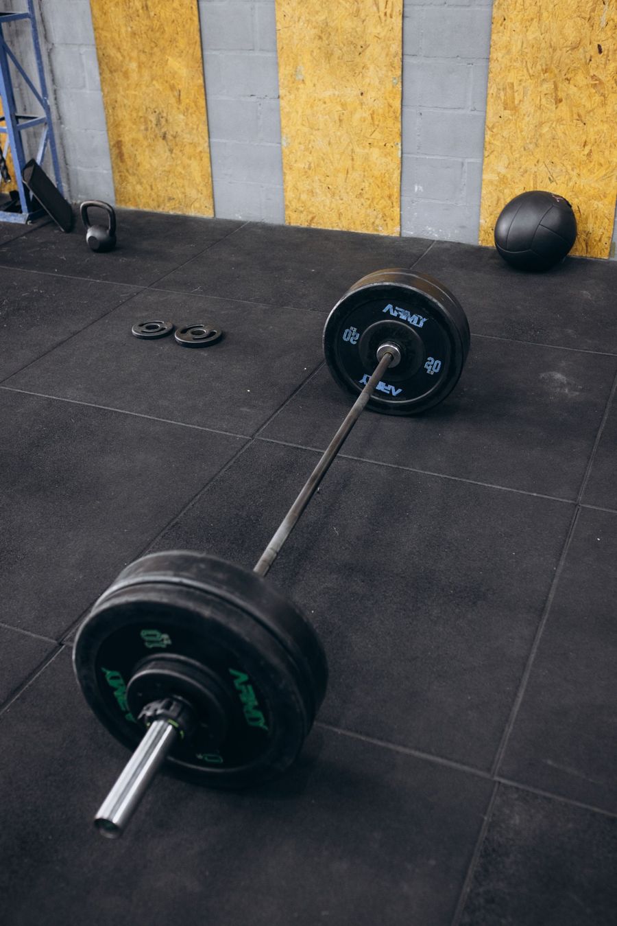 Barbell and weight plates on a rubber gym floor